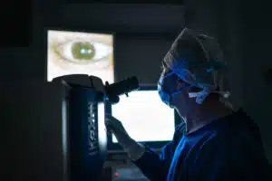 Doctor examining eye in the dark