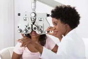 eye doctor giving directions to a patient receiving an eye exam