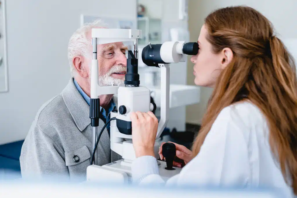 Female ophthalmic doctor diagnosing elderly patient`s sight