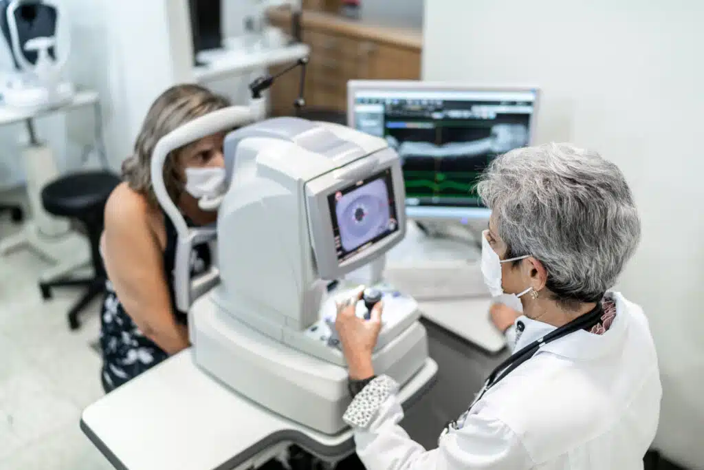 Optometrist examining patient's eyes at eye clinic