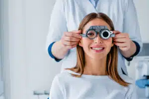 Female patient checking vision in eye clinic