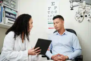 ophthalmologist talking to a patient about eye care after an exam