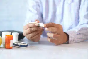 Man's hand measuring blood sugar level