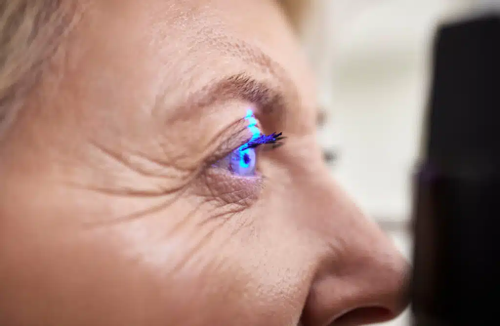 Laser eye treatment on an elderly woman with glaucoma.